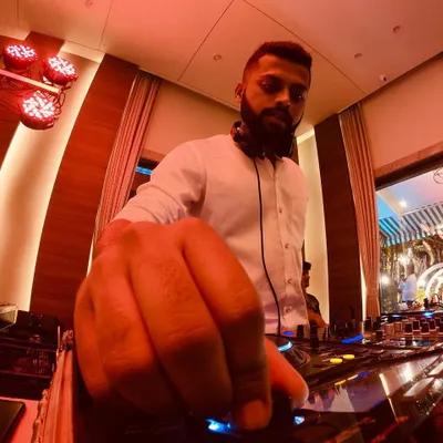 It all comes down to the details. This low-angle shot gives a close-up of my hand on the Pioneer mixer, tweaking the sound to perfection. Every adjustment is about building the next wave of energy for the crowd.