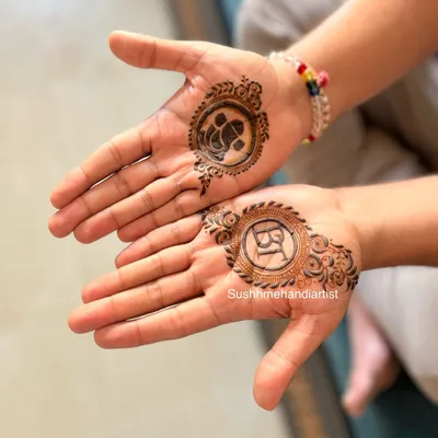 Simple and meaningful mehandi for the groom. This design features the couple's initials "RY" on one hand and a small Ganesha on the other for blessings.
