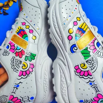 A top-down view of my custom-painted sneakers, showing the colorful fusion of mandala and floral motifs that make each pair unique.
