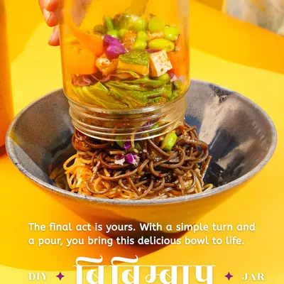 The final act is yours. This image captures the most exciting part of my DIY Bibimbap Jar experience: turning the jar upside down to release all the fresh vegetables and noodles into your bowl. It’s an interactive and satisfying way to build your meal.