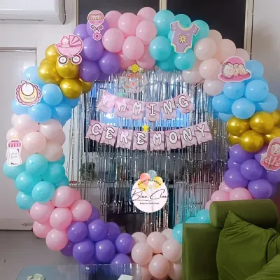 A beautiful and colorful balloon ring for a Naming Ceremony. We used a mix of pastel balloons and a silver fringe curtain to create a joyful and celebratory backdrop.