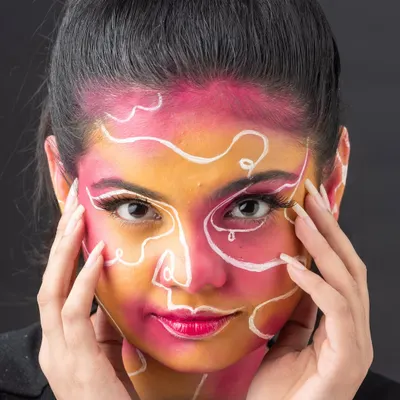 This abstract face art is a perfect example of turning a face into a canvas. Students learn to use line work and color blocking to create visually striking, artistic designs.