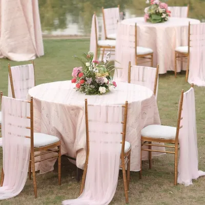 Elegance in every detail. For the 'Mantram' wedding, we styled the guest tables with soft pink linens, flowing chair drapes, and beautiful floral centerpieces that echoed the romance of the mandap.