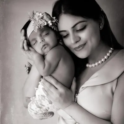 The quiet magic between a mother and her newborn. A black and white portrait strips away everything but the soft light and even softer love.
