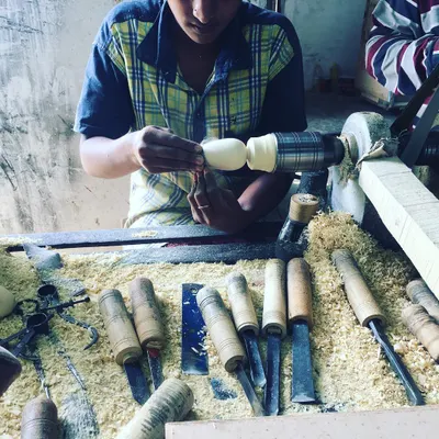 A young artisan carefully works on a new design. We are constantly blending traditional techniques with fresh ideas, ensuring the craft of Channapatna continues to evolve while honoring its roots.
