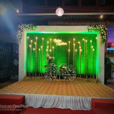 We love creating fun corners for guests to take pictures. This charming selfie point features a decorative bicycle and a "Better Together" neon sign against a lit-up green wall.
