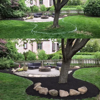 We started with just grass and created this entire wrap-around mulch bed to connect the patio to the rest of the yard. The stone border gives it a clean, permanent edge.