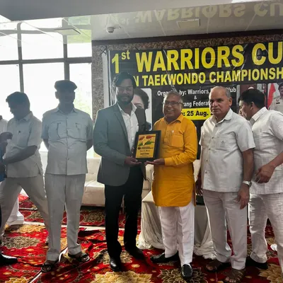 Receiving an award at the 1st Warriors Cup Taekwondo Championship. It's an honor to be recognized for my contribution to promoting martial arts.