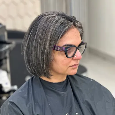 A stunning transformation to a black and white look. I used fine silver highlights to blend with her darker base, creating this high-contrast, chic bob.
