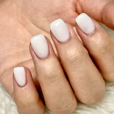 Milky perfection. This is the ultimate clean and simple look, featuring a beautiful, semi-opaque milky white polish on perfectly shaped short square nails.