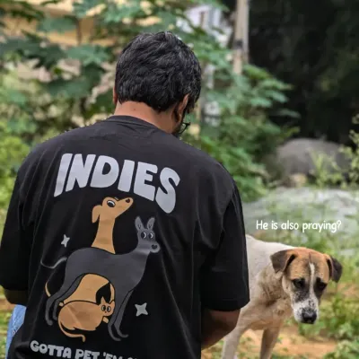The back of our "INDIES GOTTA PET 'EM ALL" t-shirt, seen here in its natural element. It’s made from light, breezy cotton, perfect for Indian weather and for showing your love for our pookies.