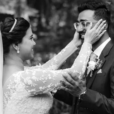 The first look. This black and white photo captures the bride's hands framing the groom's face as they see each other for the first time. It's an incredibly personal and emotional moment that I feel honored to witness.