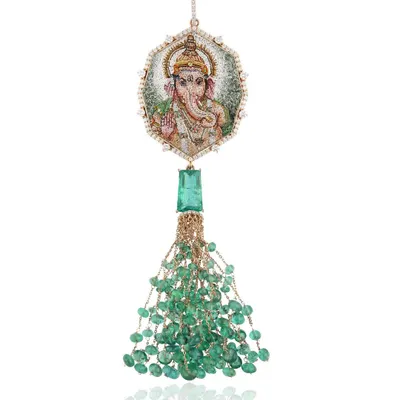 This micromosaic pendant of Lord Ganesha is handcrafted in 18k gold with Zambian emeralds and natural diamonds. The back is etched with the Vakratunda Mahakaya shloka, chanted to banish obstacles and invite prosperity.