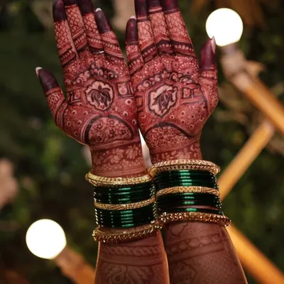 The result of my natural henna is a deep, rich stain. This photo shows the beautiful dark color on the palms, complemented by traditional green bangles.
