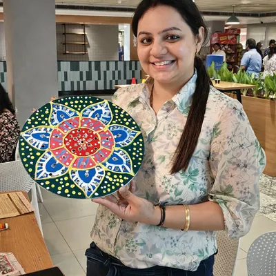 This vibrant, handcrafted Lippan art piece is a perfect example of what your team members can create. The intricate mirror work and colorful patterns make for a beautiful piece of home decor and a lasting reminder of a fun team activity.