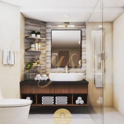 A luxurious bathroom should be a standard, not an afterthought. This design features a floating vanity, a large mirror, and a glass shower partition, with textured tiles on the accent wall to add character.