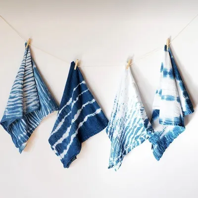 These are some of my naturally dyed napkins, each with a unique pattern from the shibori tie-dye technique. I've been working with indigo for two years, and its rich, deep blue color is truly special. They are perfect for adding a touch of handmade charm to your table setting.