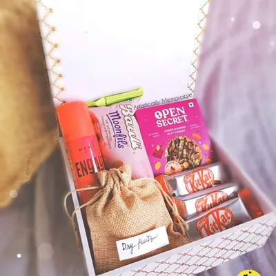 Inside my special Rakhi hamper for sisters. It's packed with a perfume, sweet and savory treats, and a little pouch of dry fruits for a healthy touch.