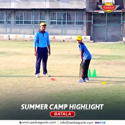 A coach provides one-on-one batting instruction during our Batala summer camp. This personalized attention is a cornerstone of our coaching philosophy.