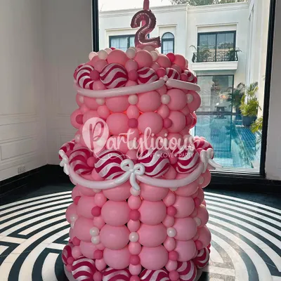 Who needs a real cake when you can have a magnificent two-tiered birthday cake made entirely of balloons? This creation, complete with candy-striped details, was a true showstopper for a second birthday.