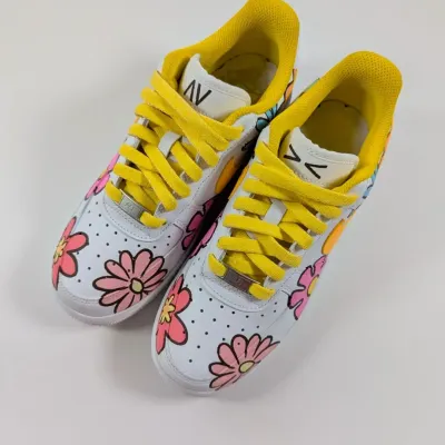 A front view of the "Air Flora1's," showing the bright floral pattern and sunny yellow laces. Perfect for summer.