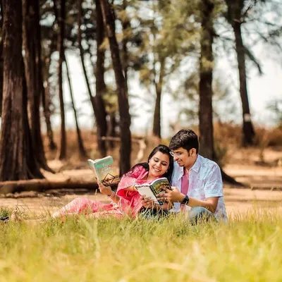 For the couple whose love story is written in books. A themed pre-wedding shoot in a forest clearing for two book lovers.