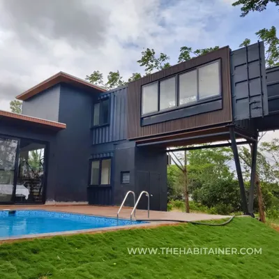 This is one of my signature projects, a hybrid home featuring a dramatic cantilevered container bedroom over the pool deck. This design showcases the architectural freedom that my custom building process allows.
