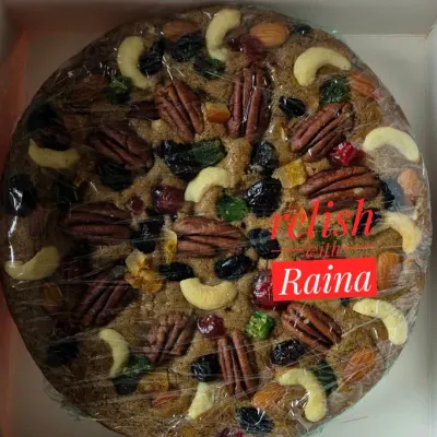 My classic Christmas fruit cake, packed and sealed for freshness. It's a dense, moist cake filled with rum-soaked fruits and a variety of crunchy nuts, perfect for festive celebrations.