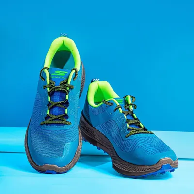 A front-on studio shot of Skechers Go Run shoes against a solid blue background. This angle provides a clear and direct view of the shoe's design, ideal for product listings and web banners.