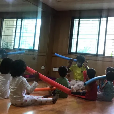 Our outdoor program brings "Serious Fun" right to your apartment's doorstep. Here, kids are engaged in a group activity using pool noodles to learn about teamwork and coordination.