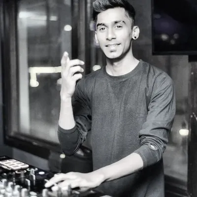 My purpose is simple: to lift your spirit and motivate you with music. A candid shot of me behind the decks, feeling the vibe.