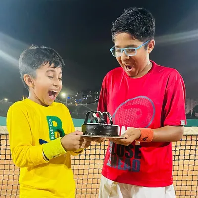This picture says it all. The excitement and joy of celebrating a tournament victory with friends and a well-deserved cake. These are the moments we cherish.