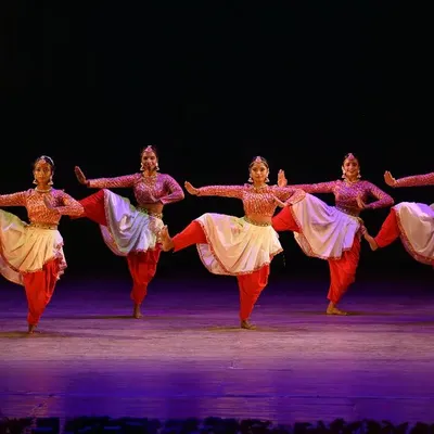Our professional performance team in a powerful semi-classical pose. This image showcases the perfect synchronization, strength, and grace our dancers bring to every stage.