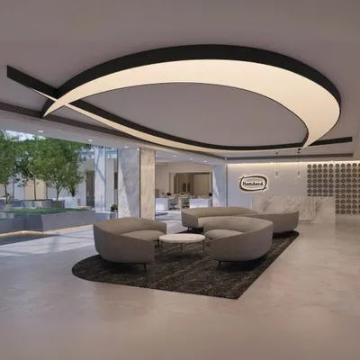 The reception at Hamdard Laboratories HQ features a dramatic, custom-designed light fixture that mirrors the brand's logo. This space sets a modern and sophisticated tone, welcoming visitors into an office centered around wellness and natural elements.