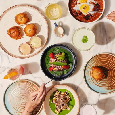 A bird's-eye view of a typical spread at Comorin. Our menu is designed for sharing, with a variety of small plates, mains, and sides that allow guests at any event to sample a wide range of flavors.