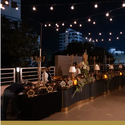 An evening event illuminated by charming string lights. Our team designs food setups that are not only functional but also enhance the overall ambiance of the celebration.
