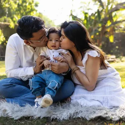 A perfect family moment, sealed with a kiss. Outdoor sessions in the park allow for natural, candid interactions and beautiful, soft lighting.