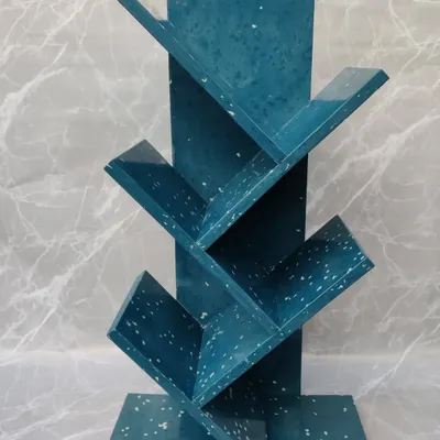 Our tree-shaped bookshelf in a beautiful blue terrazzo finish. This sturdy piece is designed to hold your favorite books while serving as a unique piece of sustainable art.