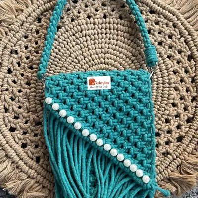 I love making these stylish accessories! This is my beautiful turquoise sling bag, handcrafted with a classic macrame knot pattern and finished with pretty pearl details. It’s the perfect size for your phone and essentials.
