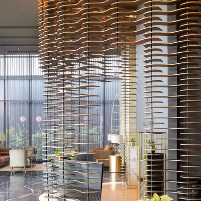 The dramatic, wave-like modular facade at the Godrej South Estate Experience Centre in Okhla. This sculptural installation serves as the reception backdrop, creating an unforgettable first impression.