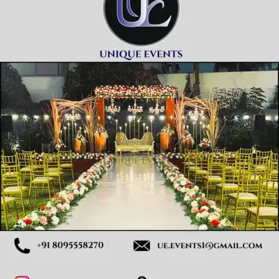 This wide-angle view shows a complete sangeet setup with a grand stage, a long, decorated aisle for performances, and organized guest seating. This demonstrates our capability in large-scale event planning and execution.
