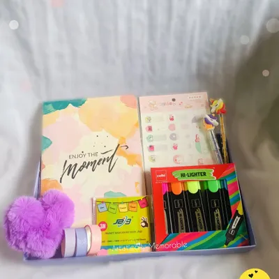 A fun and colorful stationery hamper, perfect for a little sister or niece's birthday. It's filled with a notebook, highlighters, washi tapes, and a fluffy heart keychain.