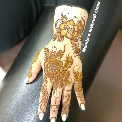 A beautiful, full floral piece on the back of the hand. The shading on the petals gives it a very realistic look.