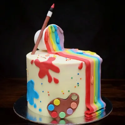 I created this fun artist-themed cake for a creative soul. It features a rainbow waterfall of fondant paint spilling from a bucket, paint splatters, and a little artist's palette, with vibrant rainbow layers hidden inside.