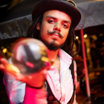 A portrait of our contact juggler in his Steampunk attire. He presents the crystal ball as if it were a magical artifact, adding to the illusion of the act.