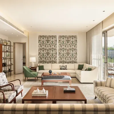 A living room from our Max128 project, where contemporary furniture is mixed with Indian-patterned fabrics. The open layout connects to the dining area and deck, creating a spacious and sociable environment.