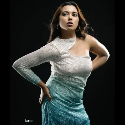 Make a statement in this unique off-white and blue shaded sequin dress. The one-shoulder design and choker neck create a modern, high-fashion look perfect for a glamorous party.