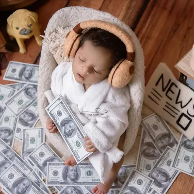 This little boss baby is already taking over, surrounded by money, music, and the morning news. It's a hilarious and adorable theme that always gets a great reaction.