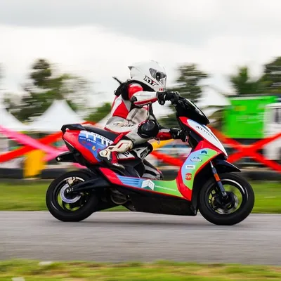 A rider leans an Ather 450X electric scooter into a corner during India's first EV racing festival, held right here at Aruani Grid. We are at the forefront of the electric racing revolution.