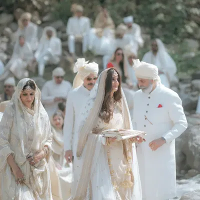 The bride's serene procession during her wedding by the Ganga in Rishikesh. The all-white theme for the guests created a tranquil and visually unified atmosphere.